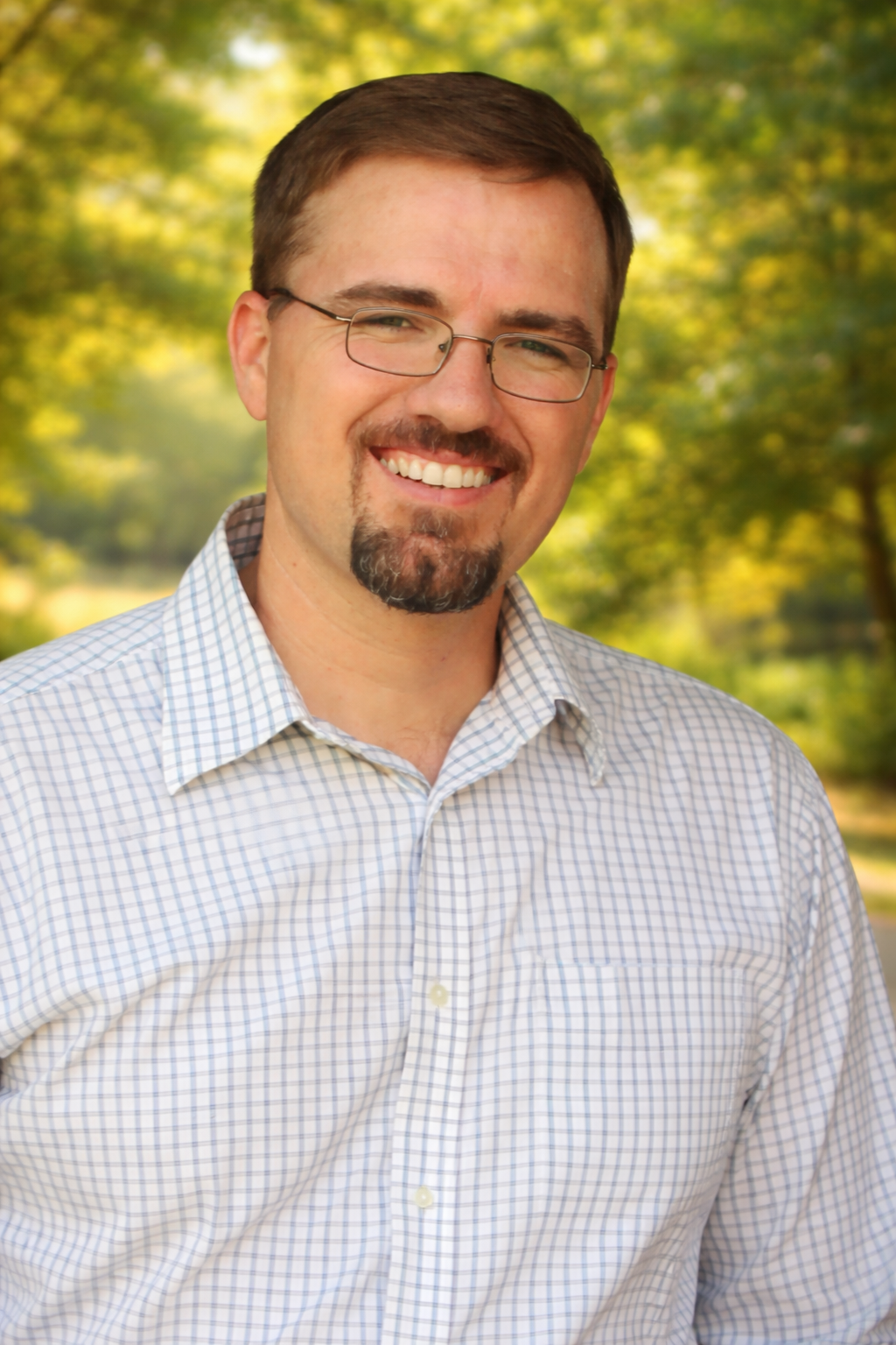 Smiling man in a sunlit park